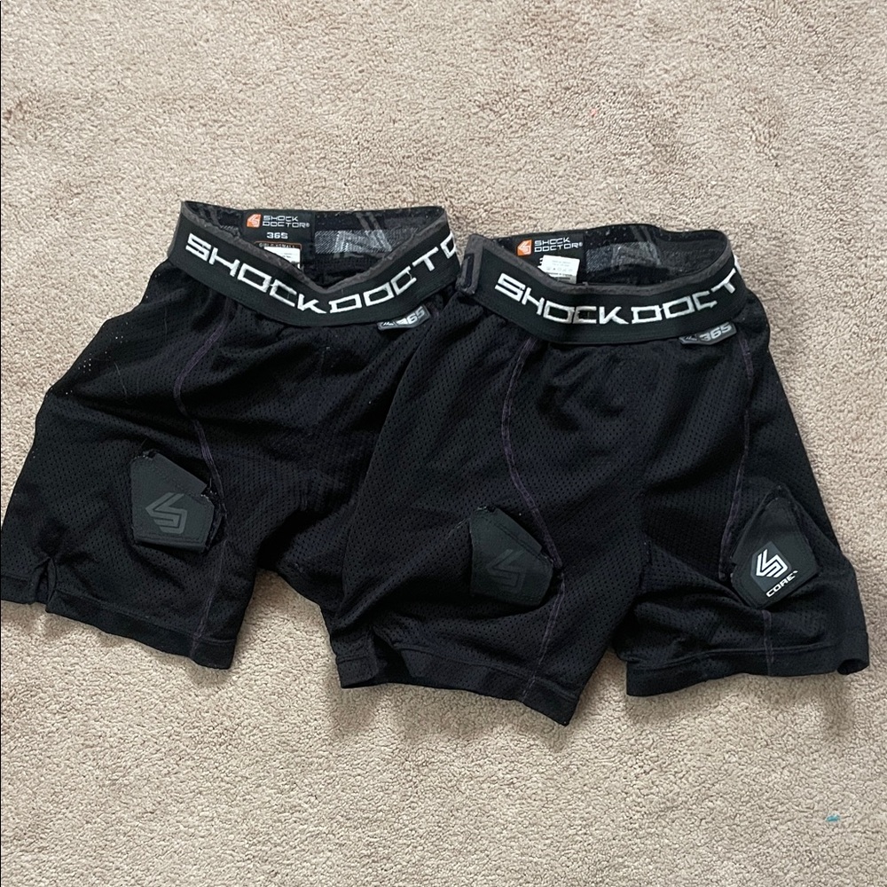 2 pairs of girls hockey pelvic protector shorts.